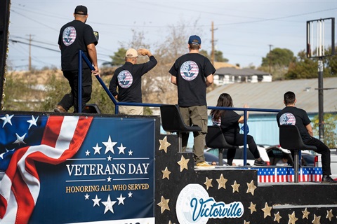 City of Victorville Employees riding a parade float for Veterans Day