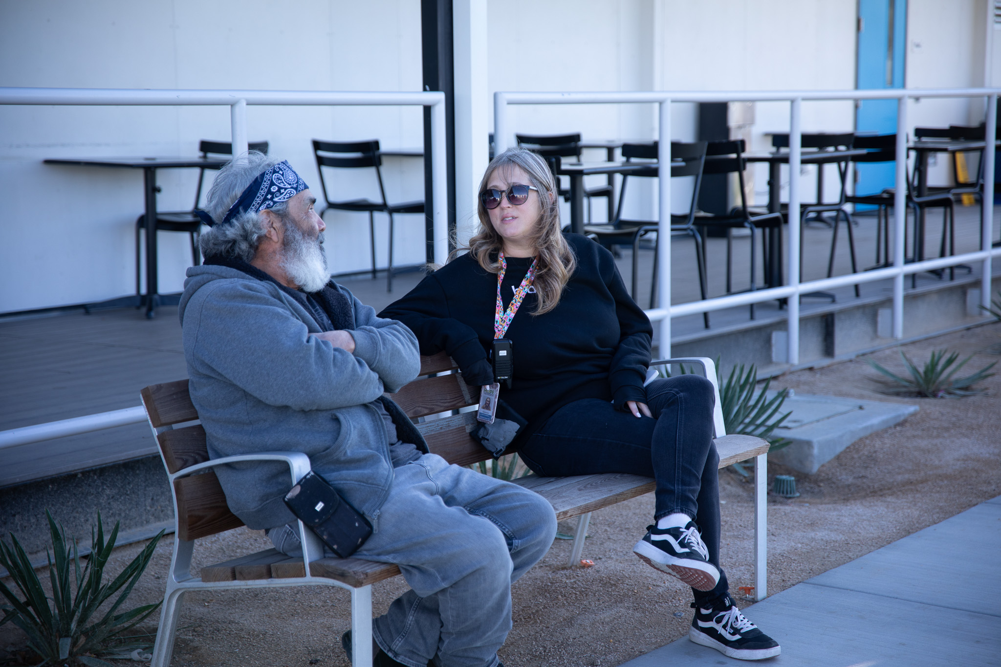 Case worker and client at the Victorville Wellness Center talking on bench