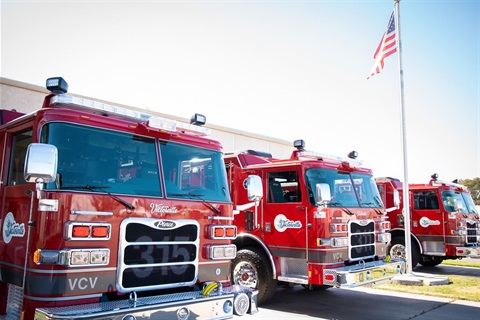 Three fire engines parked in a uniformed line