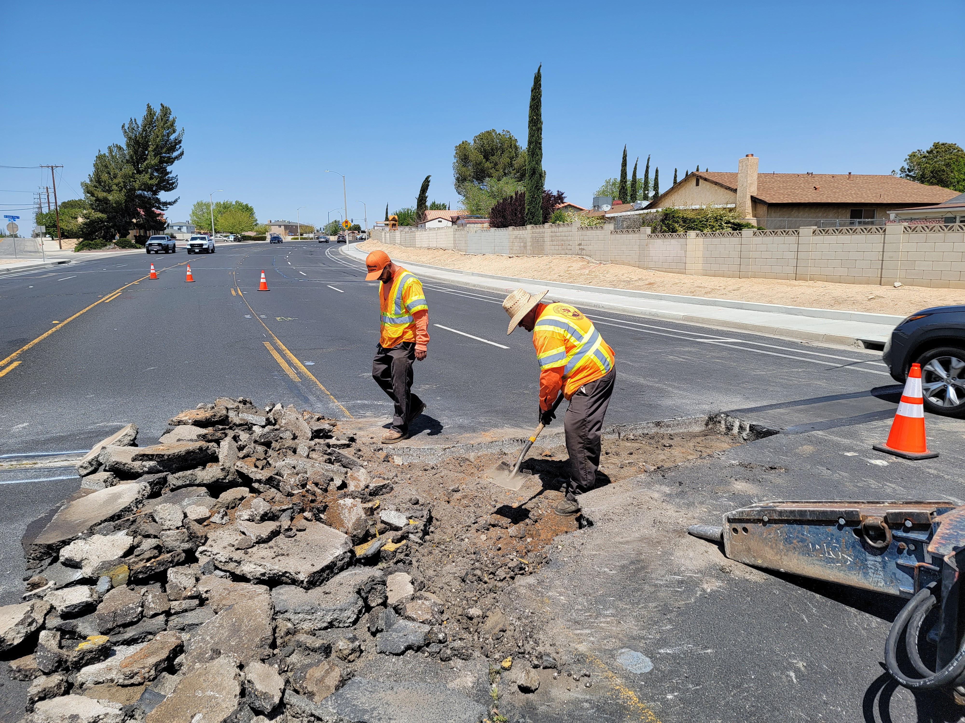 Public Works crew performing asphalt repair on a city street