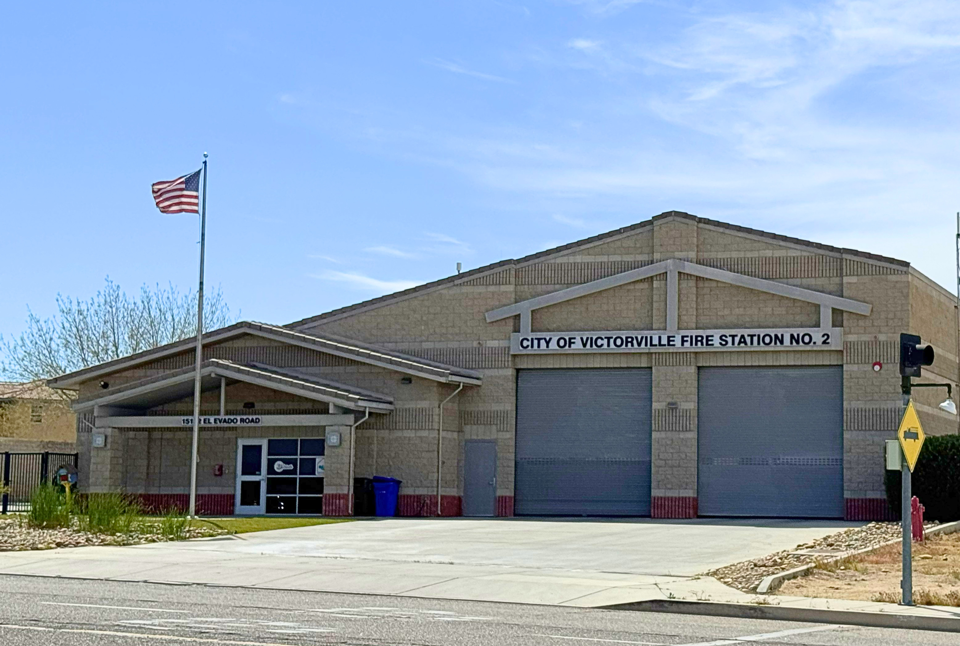 Photo of the street view of fire Station 312 depicting the garage bays and front door