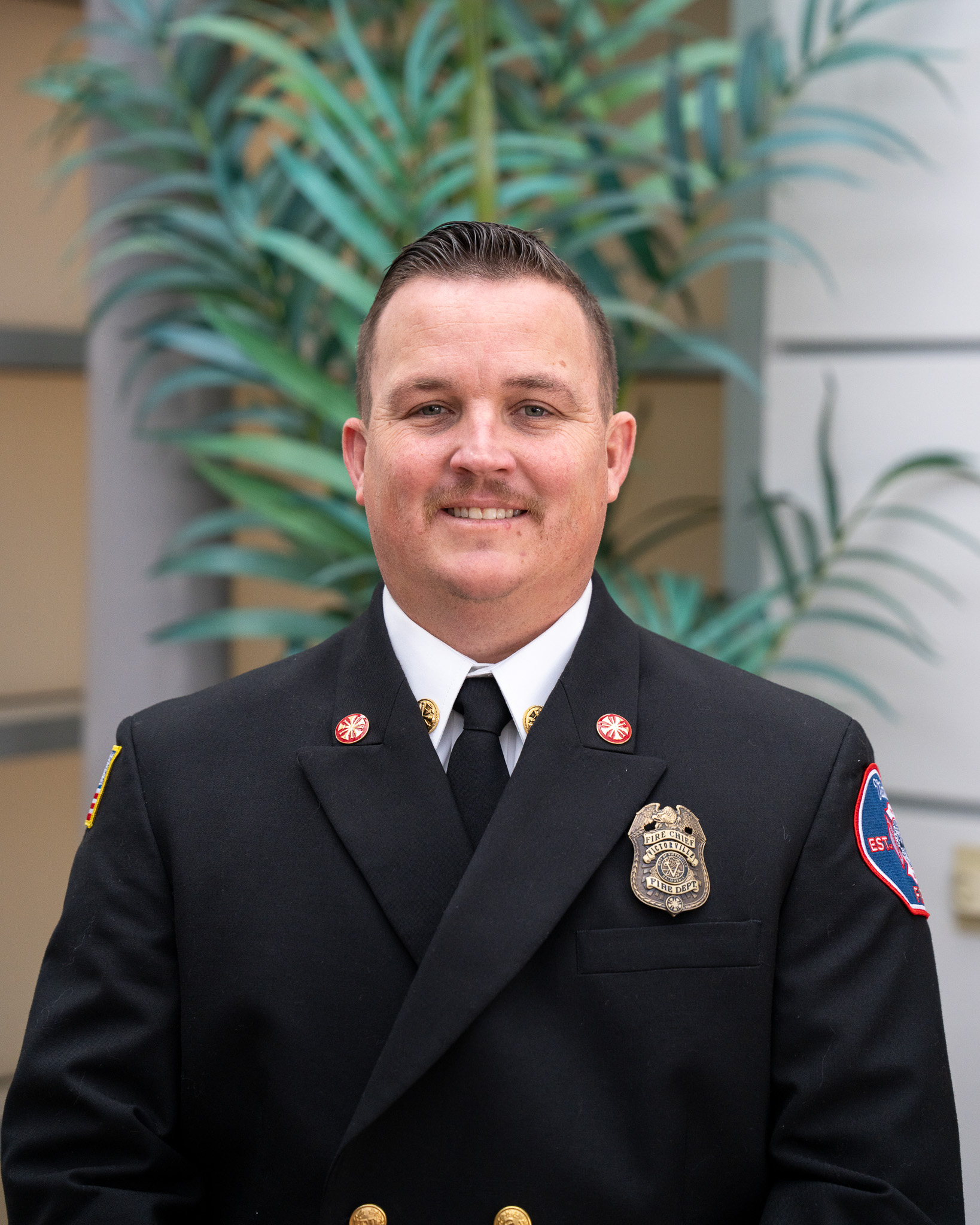 Photo of Fire Chief Bobby Clemmer in Class A uniform with badge affixed to left lapel